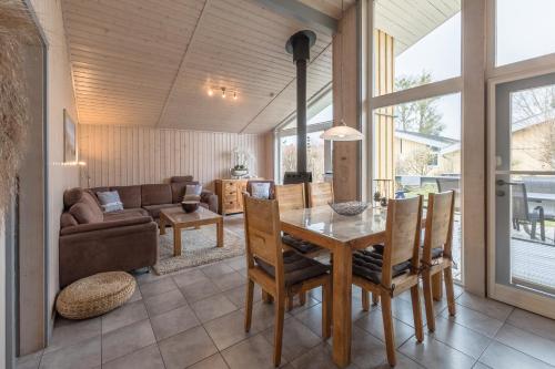 a dining room with a table and a couch at Seeschwalbe 47 in Rechlin