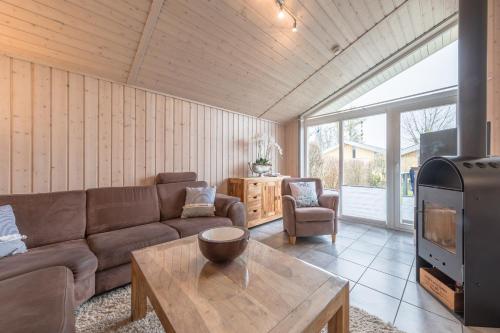 a living room with a couch and a table and a tv at Seeschwalbe 47 in Rechlin
