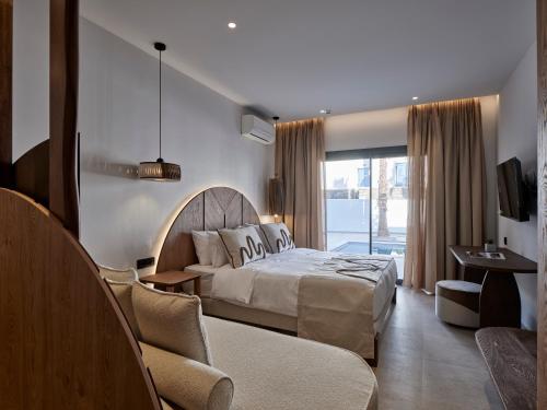 a hotel room with a bed and a couch at Iria Blue Mykonos in Platis Yialos Mykonos