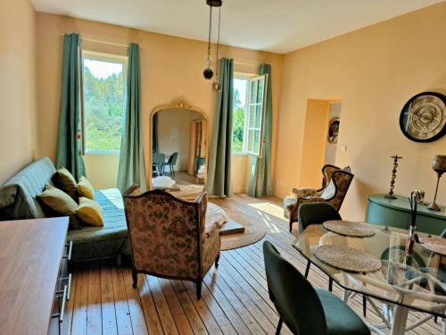 un salon avec une table et des chaises dans l'établissement La villa des figuiers, à Saint-Bonnet-du-Gard