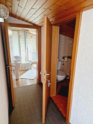 an open door to a bathroom with a toilet at Haus Rätikon in Vandans