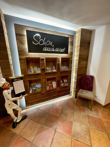 a man walking past a sign in a book store at Heisshof in Schladming