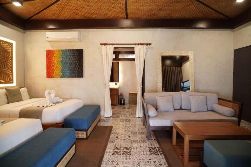 a living room with two beds and a couch at Station One Beach Resort in El Nido