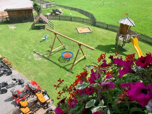 a toy park with a playground and a swing at Heisshof in Schladming