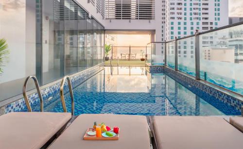 a swimming pool with a tray of toys on a balcony at Gosia Hotel in Nha Trang