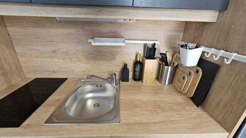 a kitchen counter with a sink and utensils at Mobile home Pelin with shared pool in Pirovac