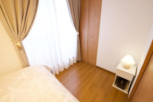 Postel nebo postele na pokoji v ubytování 今帰仁村兼次戸建て