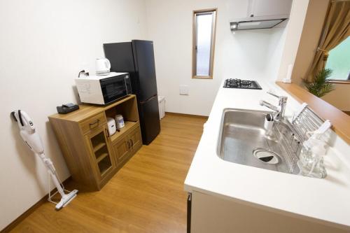 Kuchyň nebo kuchyňský kout v ubytování 今帰仁村兼次戸建て