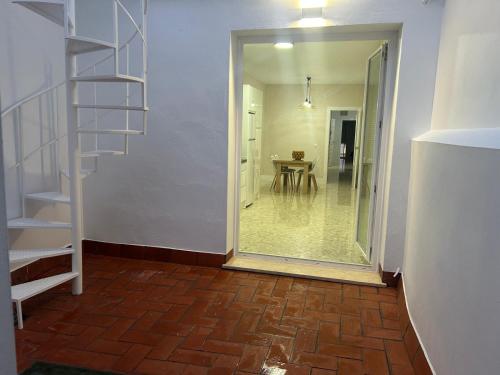 a hallway with a staircase and a room with a table at Loft Central in Lepe