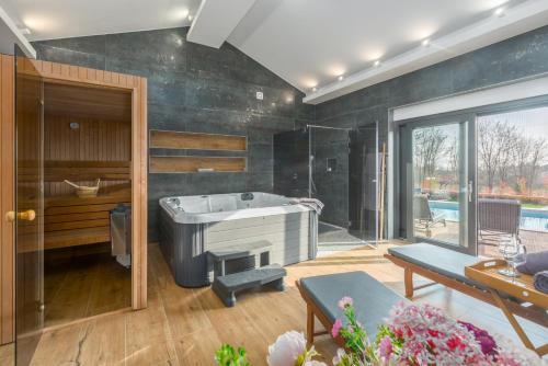 a bathroom with a tub and a swimming pool at Villa Harmony for 8 people in Central Istria with 50 m2 private pool and sea view in Pinezići