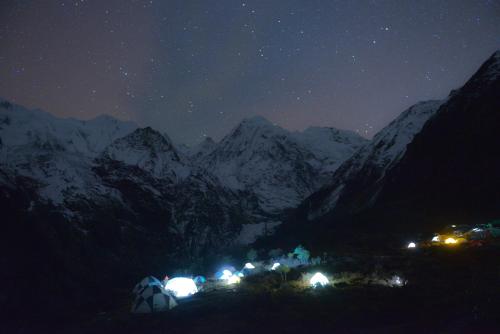 a group of tents in the mountains at night at 香格里拉喀玛美敦民宿 in Shangri-La