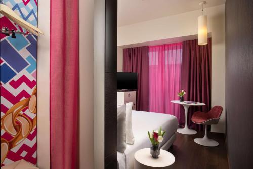 a hotel room with a bed and a table at Nhow Milan in Milan