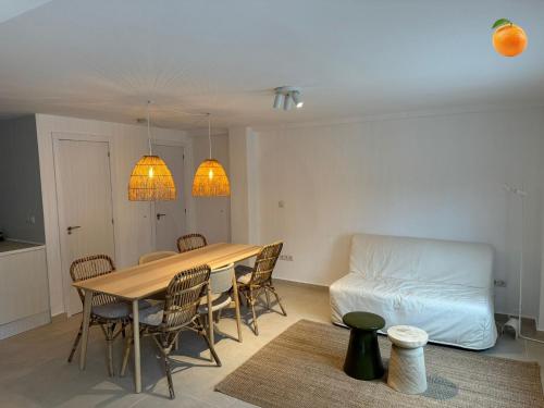 a dining room with a table and chairs and a couch at Fully private villa for 12p with large pool in Valencia-Náquera in Náquera
