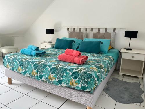 a bedroom with a bed with two pillows on it at Le chant du Lagon in La Saline les Bains