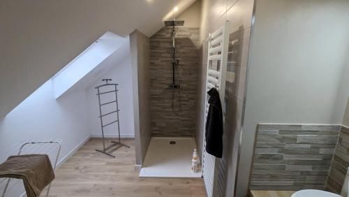 a bathroom with a walk in shower next to a staircase at 2-bedroom Apartment With Ac & Wifi in Soultz-Haut-Rhin