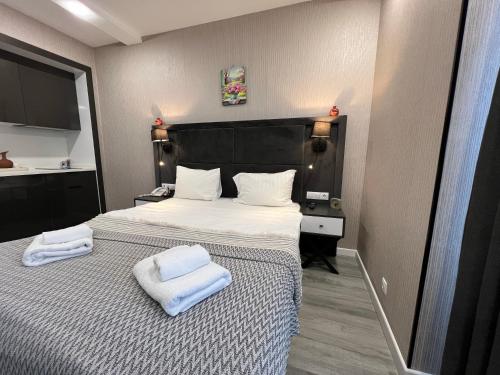 a bedroom with a bed with two towels on it at alliance panorama Batumi in Batumi