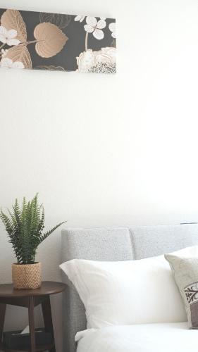 a bedroom with a bed and a table with a plant at Villa Lotus in Kamakura