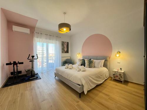 a bedroom with a large bed and a large window at Casa Bouquet in Ladispoli