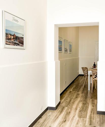a living room with a table and a white wall at Giovì - Premium Apartment in Mazara del Vallo