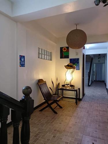 a living room with a chair and a lamp on a table at Casa Dolores Laiya Batangas in San Juan