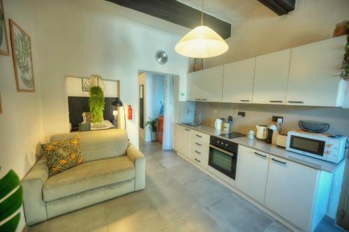 a living room with a couch and a kitchen at Cozy flat. Swim beach 2 minutes walk. The Old Valletta MCRI1-1 in Valletta