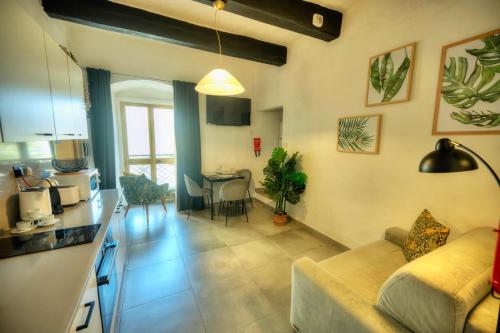 a living room with a couch and a dining room at Cozy flat. Swim beach 2 minutes walk. The Old Valletta MCRI1-1 in Valletta