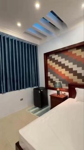 a bedroom with a bed and a television in it at Cao Nguyên 2 Villa Hà Giang in Ha Giang