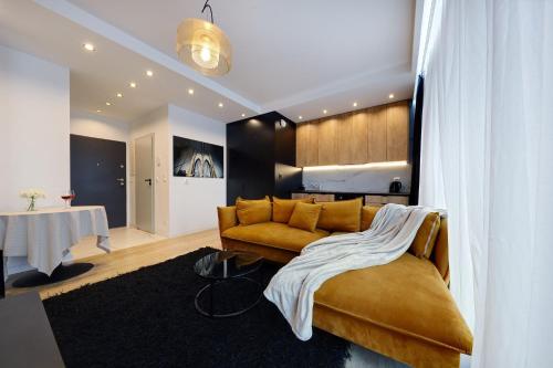 a living room with a couch and a table at Central Apartments Katowice - City Center - Luxury Studio - S74 in Katowice