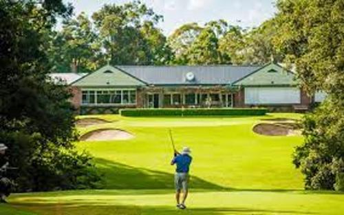 a man swinging a golf club on a golf course at Hills Bed & Breakfast in Pennant Hills