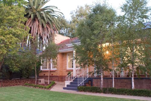 a house with a palm tree in front of it at Casa thirty-six, 3BR, Central Location in Tanunda