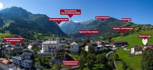 a village in a valley with mountains in the background at Appartements Bergfried - Ski In Ski Out, inklusive Sommerkarte, zentral mit Ausblick über Kaprun in Kaprun