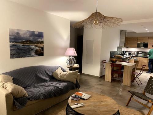 un salon avec un canapé et une table dans l'établissement Elégant appartement T3 sur le golfe du Valinco, à Propriano