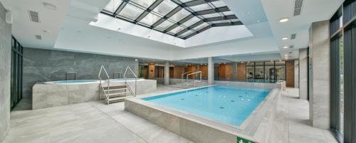 a large swimming pool in a building at Green Port Spa&Wellness Rent Partners in Kołobrzeg