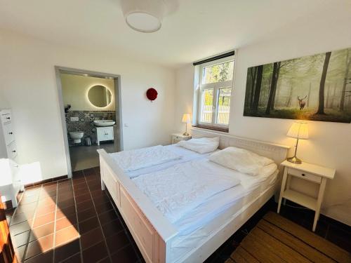 a bedroom with a large bed and a window at Kuckucksnest - Ferienwohnung mit Traumblick im Schwarzwald in Bad Wildbad
