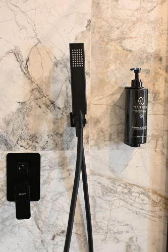 a microphone on a tripod next to a wall at Hotel Centrum Malbork in Malbork