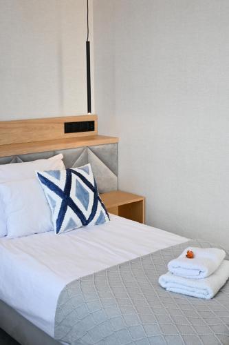 a bedroom with a bed with towels on it at Hotel Centrum Malbork in Malbork
