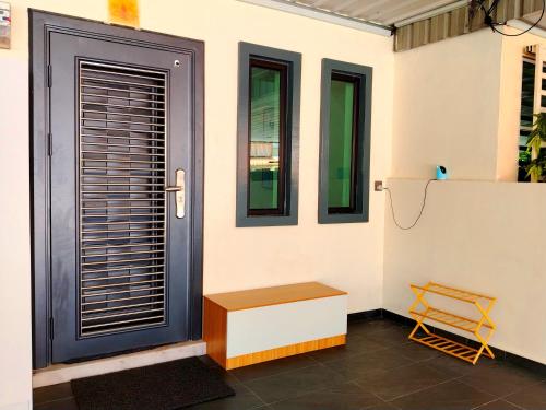 a room with a door and two windows and a bench at Mootopia BM homestay room rent in Bukit Mertajam