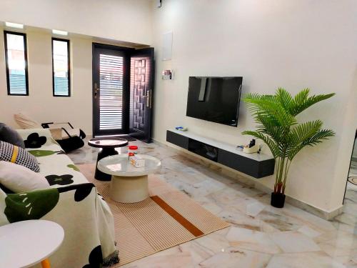 a living room with a couch and a tv at Mootopia BM homestay room rent in Bukit Mertajam