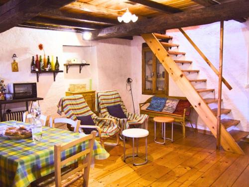 a room with a table and chairs and a staircase at B&B Levigliani in Levigliani