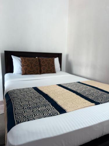 a couple of beds in a room at Home Living Unit in Galle