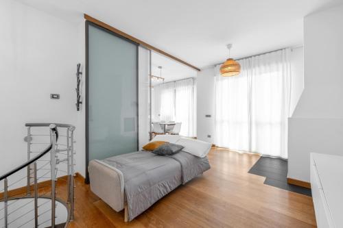 a bedroom with a bed and large windows at Milano-Rho Fiera Exclusive stay private parking in Rho