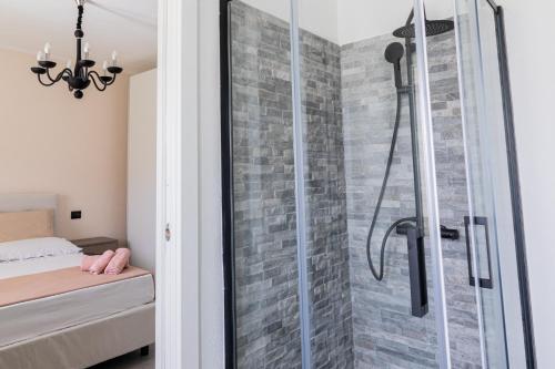 a shower with a glass door in a bedroom at VivimiHome - Monti House in Monti