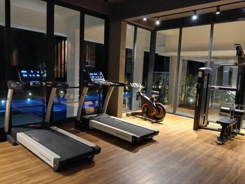 a gym with treadmill and exercise equipment in a building at Ang Roxy Apartment A in Sematan