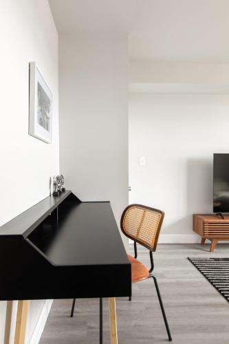 a black desk and a chair in a room at Philly Getaway - Chic Stay Near Center City in Philadelphia