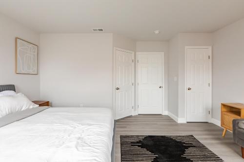 a white bedroom with a bed and a couch at Philly Getaway - Chic Stay Near Center City in Philadelphia