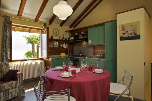 a kitchen with a table with a red table cloth at Rustico alla Spiaggia in Carmine