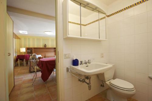 a bathroom with a toilet and a sink and a mirror at Rustico alla Spiaggia in Carmine