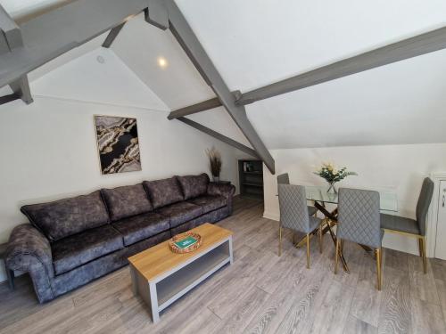 a living room with a couch and a table at Apartment 3 The Baileys Cwm in Cwm