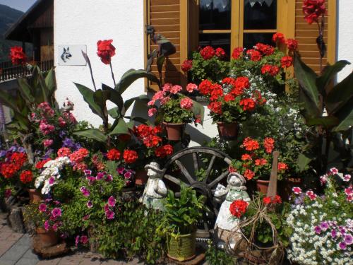 a garden of flowers in front of a house at Haus Ploner - Pichlerhof in Chienes