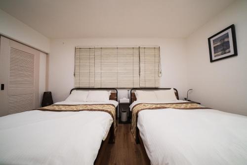 Ένα ή περισσότερα κρεβάτια σε δωμάτιο στο SunstVilla Awaji